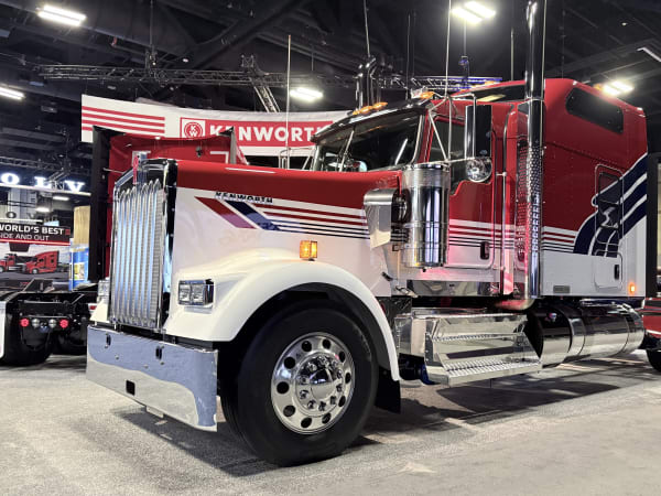 Classic long nose Kenworth truck with red white and blue patriotic color scheme