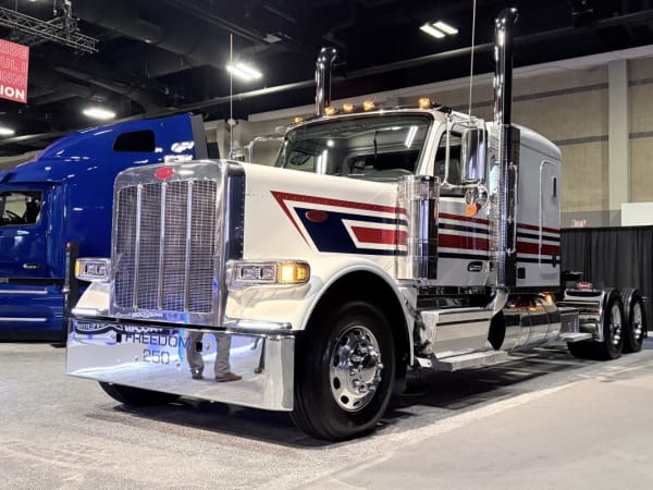 Classic long nose Peterbilt truck with red white and blue patriotic color scheme