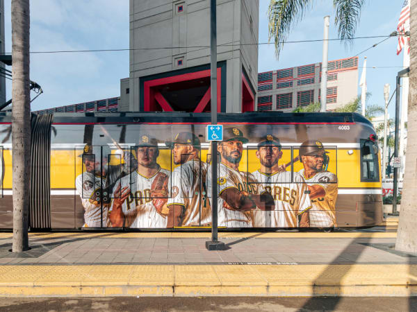 A San Diego Metropolitan Transit System trolley wrapped with a Padres player advertisement.