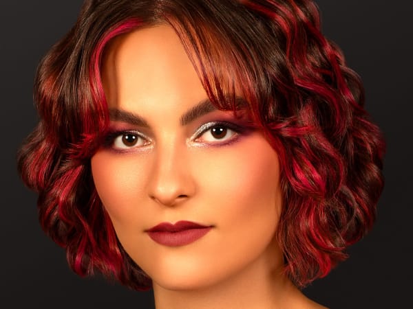 A model with short red wavy hair