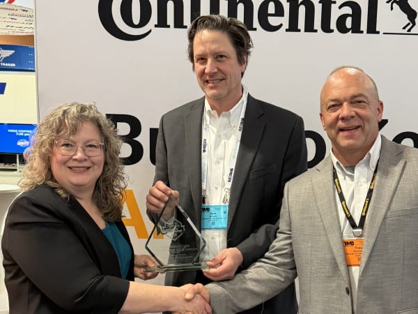 Woman and two men shaking hands