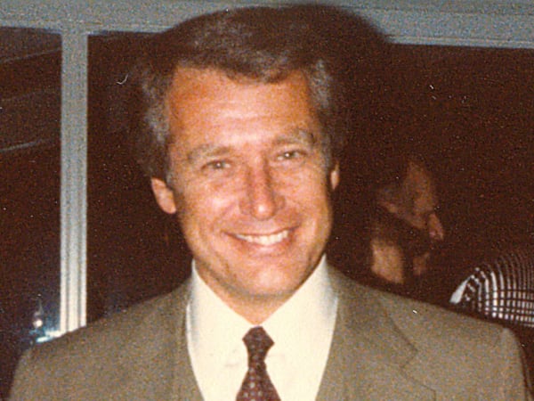Portrait of aGary Tepas in a suit and patterned tie at a company event.