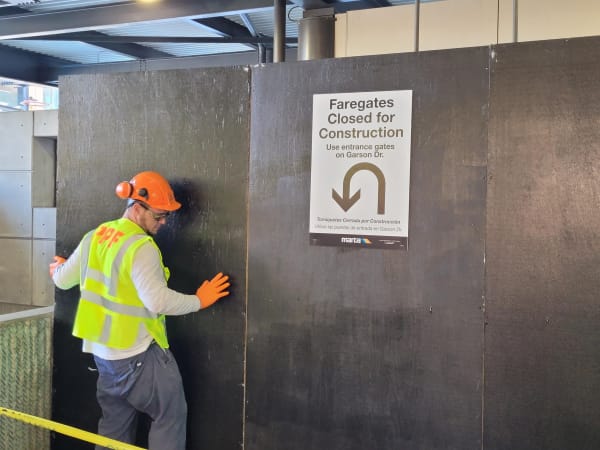 Crews installing construction barriers at Lindbergh Center Station to ensure customer and employee safety as new better Breeze equipment is installed.