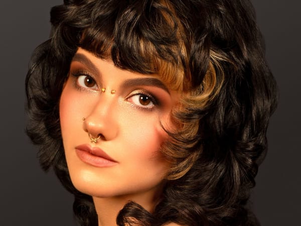 A model with brown curly hair