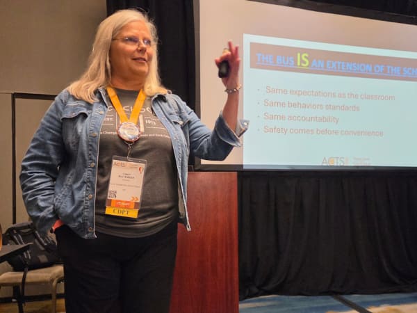 Cindy Buttenmeier presents a session on student behavior at NAPT ACTS 2026, emphasizing that school buses should follow the same behavioral expectations as classrooms.