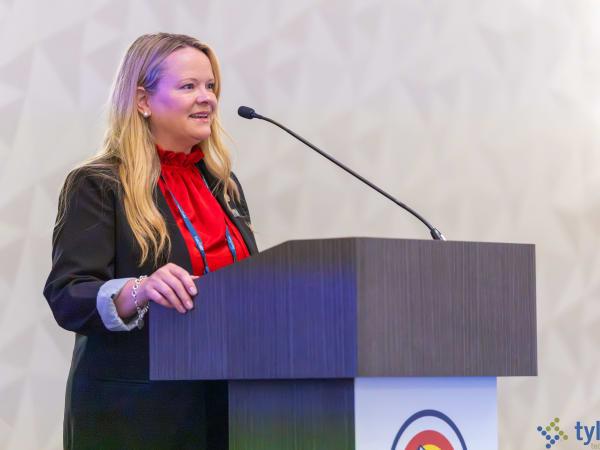 Michelle Atwell of the National Highway Traffic Safety Administration presents federal school bus safety updates on a stage at the NSTA event