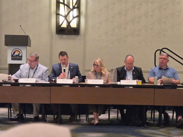 NSTA leadership conducts the association's business meeting, with board members seated at a long table discussing organizational updates during the 2026 annual conference.