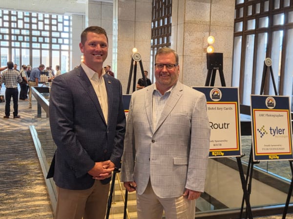 NSTA Executive Director Curt Macysyn and NSTA President Patrick Dean pose together in the conference lobby at the 2026 National School Transportation Association Annual Meeting & Convention in Denver.