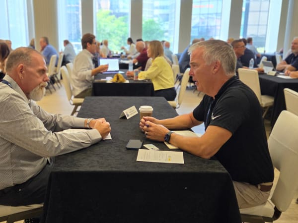Two attendees participate in a one-on-one speed networking meeting during a supplier-operator networking session at the 2026 NSTA Annual Meeting & Convention.