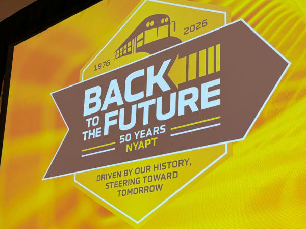 A large screen displays the "Back to the Future: 50 Years NYAPT" conference theme, celebrating the association's 50th anniversary in 2026.