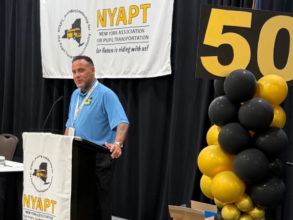 NYAPT President Marc Medina, transportation director for Farmingdale School District, welcomes attendees during the association's 50th anniversary conference.