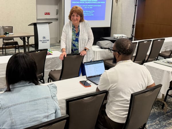 Susan Shutrump speaks with attendees before leading her educational session on creating safer, calmer school bus rides during the 2026 NYAPT conference in Saratoga Springs.