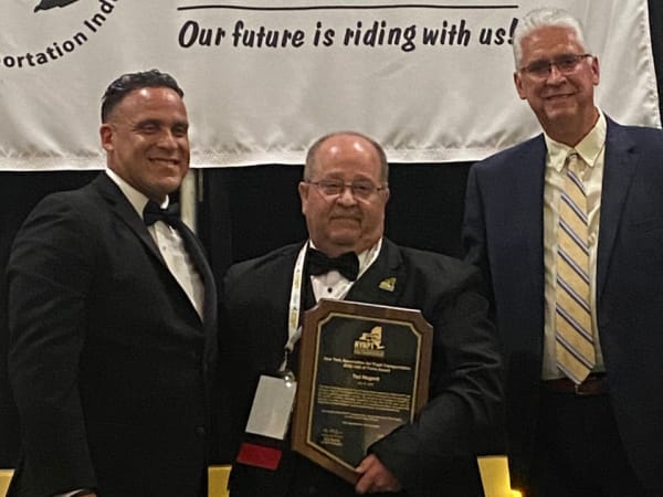 NYAPT President Marc Medina (left) and Executive Director David Christopher (right) present an award to past president Ted Nugent during the association's 50th anniversary conference.