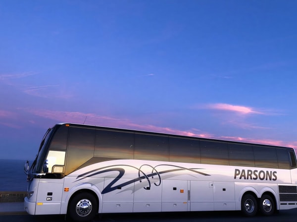 Parsons & Sons motorcoach with purple skyline