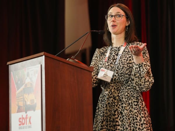School Bus Fleet Executive Editor Amanda Huggett speaks from the podium during the 2026 School Bus Fleet Connex event.