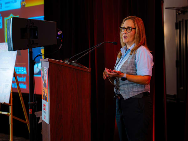 AMF Bruns’ Maritza Valentin speaks from the podium during the 2026 School Bus Fleet ConneX in Scottsdale.