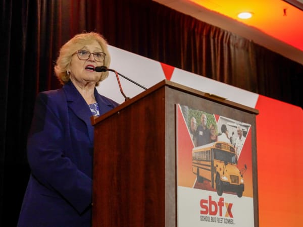 NAPT CEO and Executive Director Molly McGee Hewitt speaks from the podium during the 2026 School Bus Fleet ConneX.