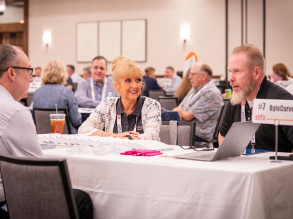 A school transportation professional meets with ByteCurve representatives during a one-on-one meeting at School Bus Fleet Connex.
