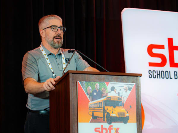 Chad Duncan speaks from the podium during an education session at the 2026 School Bus Fleet Connex event.