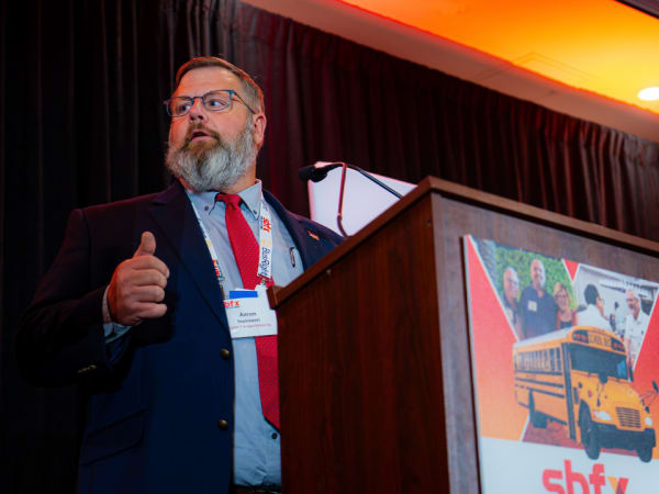 Aaron Sepkowski speaks from the podium after being recognized as School Bus Fleet's 2026 Contractor of the Year.