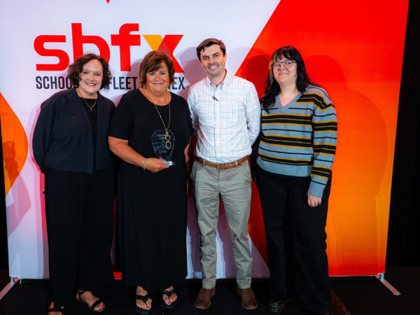 Annette Brown of Wa-Nee Community Schools poses with her 2026 School Bus Driver Hero award alongside Amy Rosa, Blake Barnes, and School Bus Fleet’s Elora Haynes.