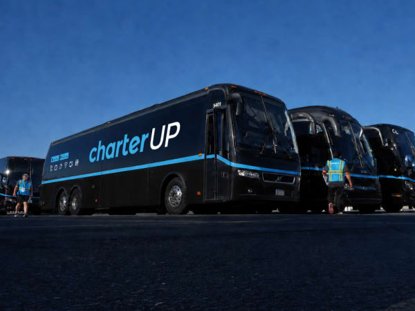 CharterUP motorcoaches stand staged for World Cup service.