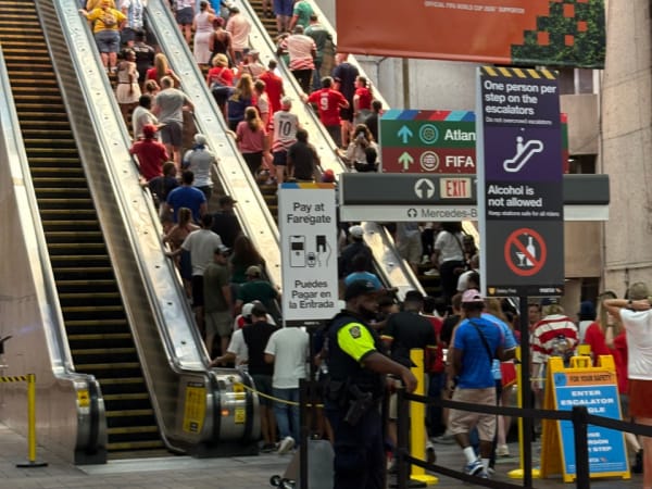 World Cup crowds go up escalators.