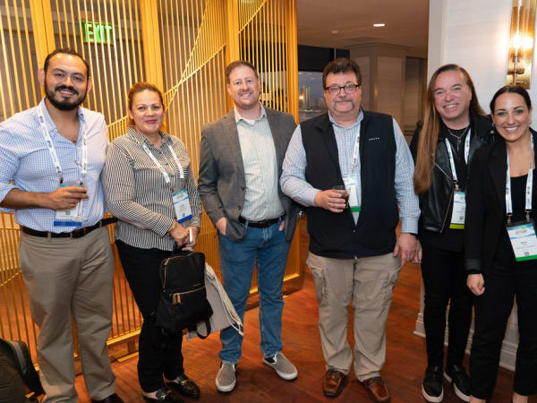 Six attendees at cocktail reception. 