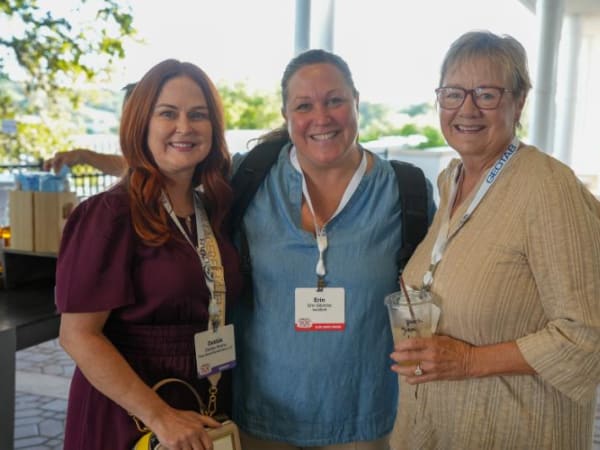 Three woman standing, pose for camera. 