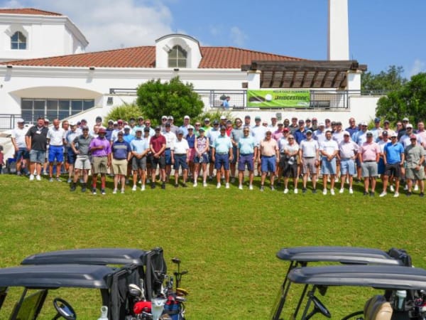 Group of 50 golfers pose for photo. 
