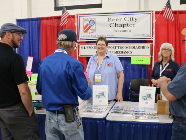 Group of people at a booth for ATHS Beer City chapter