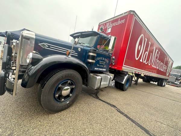 Old Diamond T antique truckk pulling a trailer with Old Milwaukee logo