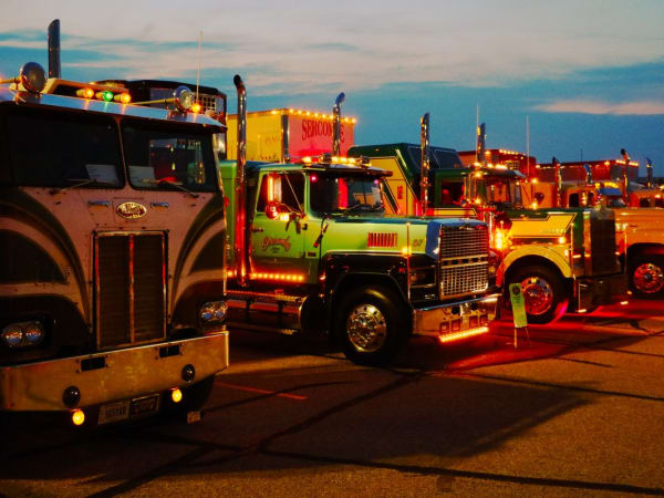 A line of antique trucks at sunset
