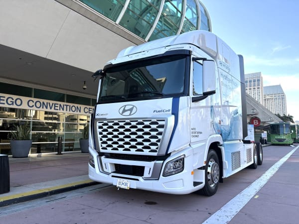 White Hyundai Xcient FCEV cabover outside convention center