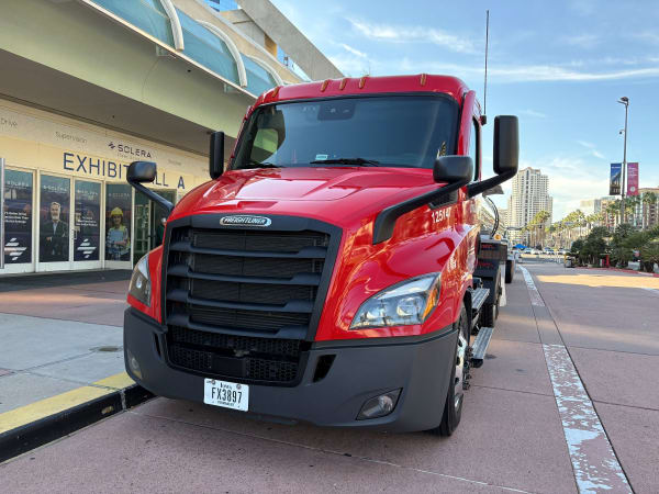 Red Freightliner truck outside convention center
