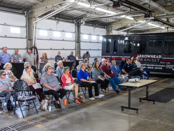 A presenter shared project details with the RideSmart 2025 launch event crowd.