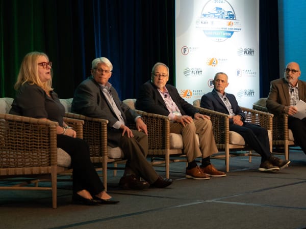 Panelists deliver seminar on stage. 