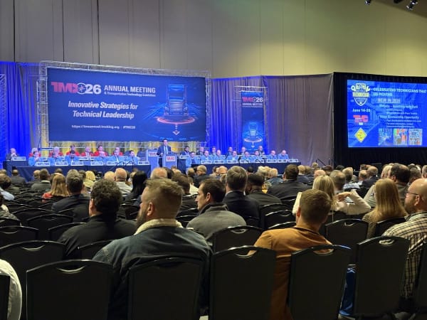 People sitting in a large room looking at a stage