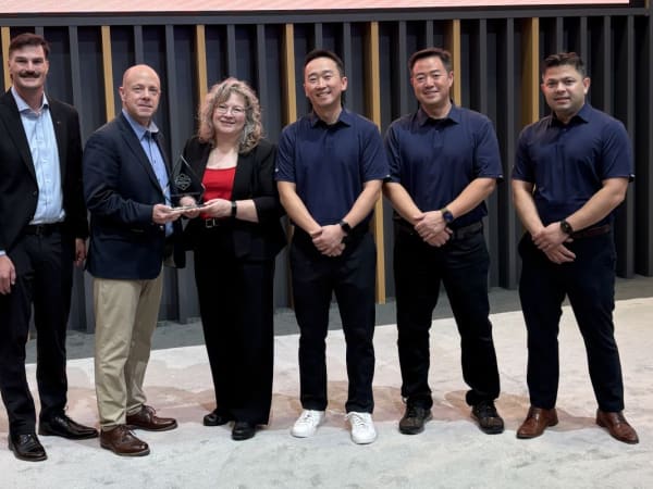 Group of people posing with trophy