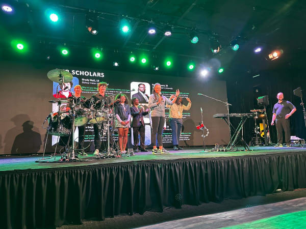 Interns on stage at an offsite party. 