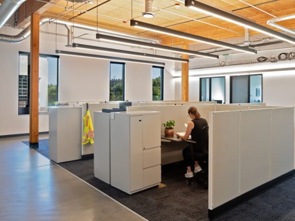 Interior image of C-TRAN's campus expansion work room with cubicles and timber ceiling.