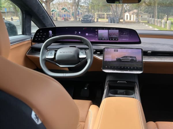 Full frontal view of the dashboard control area from the rear seat.