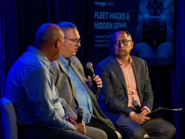 Three panelists on stage during seminar. 