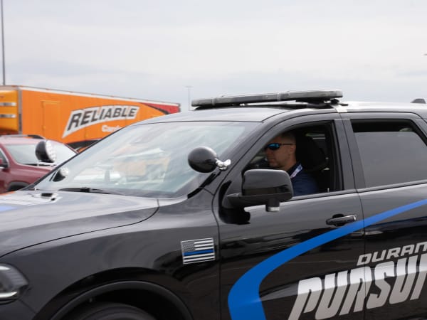 A man is seen driving a black Dodge Durango Pursuit.
