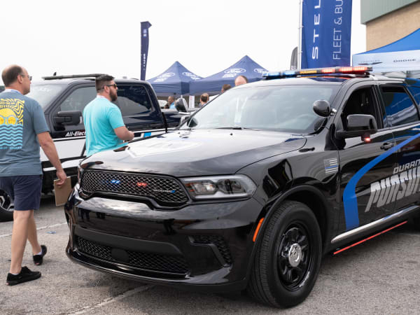 Attendees walk around a Dodge Durango Pursuit, ready for its next test drive.