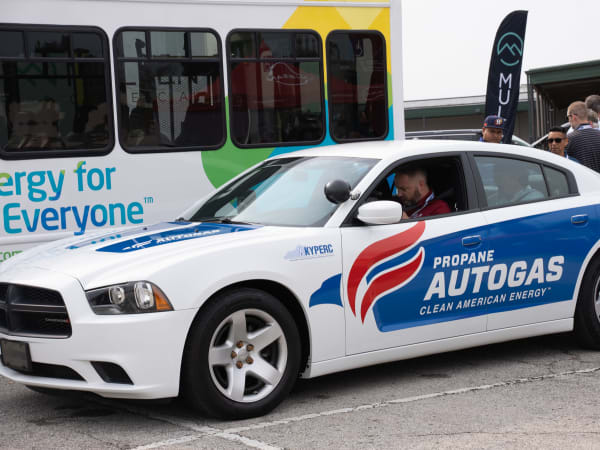 A Ford Champion transit bus and Dodge Charger pursuit sit side-by-side in the Ride & Drive lineup.
