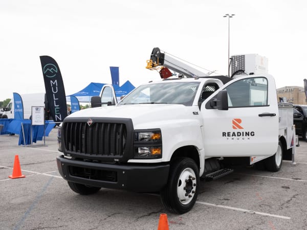 An International CV day cab truck with a Reading Truck service body and Stellar 7621 hydraulic service crane is on display in the Vehicle Showcase lineup.