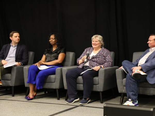 Panelists on stage during a seminar. 