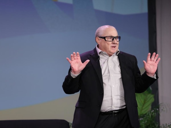 Man delivers keynote from stage. 