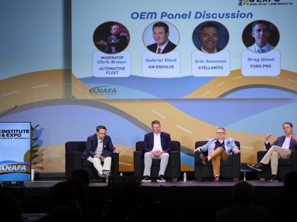 Panelists on stage during a seminar. 